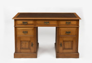 An antique Australian twin pedestal desk, kauri pine with embossed tooled leather top, late 19th century, 77cm high, 122cm wide, 55cm deep