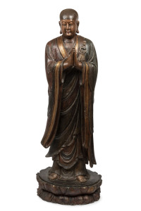 A LOHAN tall standing Chinese figure, carved and painted wood with inset glass eyes, Suzhou, Jiangsu, Ming Dynasty. 182cm high. Note: Exhibited at The Art Gallery of South Australia "AWAKENING THE ART OF BUDDHISM", Dec. 2016 to Oct. 2017. PROVENANCE: The Judith Heaven an the late Barrie Heaven collection, South Australia.