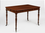 An antique English mahogany desk with fine ring turned legs and centurion skirt decoration, early 19th century, 74cm high, 115cm wide, 75cm deep