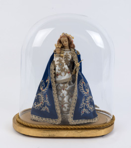 A large oval French glass dome containing a Virgin Mary and baby Jesus wax figure in embroidered costume on a gilt painted timber base with four bun feet, 19th/20th century. Dome measurements 35cm high, 31cm wide.