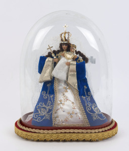 A large oval French glass dome containing a Virgin Mary and baby Jesus wax figure in embroidered costume on a red velour and gold braided timber base with four bun feet, late 19th/20th century. Dome measurements 36.5cm high, 29cm wide.