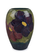 MOORCROFT "Clematis" English pottery vase on green blue ground, circa 1920s, stamped "Moorcroft, Made in England", with hand signed "W. M" monogram, ​17.5cm high