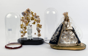 Two cylindrical French glass domes with Virgin Mary and baby Jesus religious statues on oval timber bases, 19th and 20th century. Dome measurements 36cm high, 15cm diameter (the smaller), and 41cm high, 15.5cm diameter (the larger)