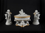 Parian and gilt candlesticks with cupid decoration by Franklin Mint together with a Royal Dux lidded urn (damaged), 20th century, (3 items), candlesticks 24cm high