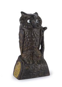 An American painted cast iron "OWL" novelty money bank, later cast brass base, late 19th century, 19cm high,