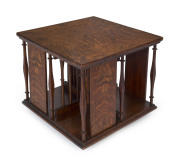 An English Arts & Crafts oak and marquetry tabletop revolving bookstand, with retailer's ivoreen plaque "BUCKLEY & NUNN Ltd. MELBOURNE", circa 1900, 33cm high, 39cm wide, 39cm deep