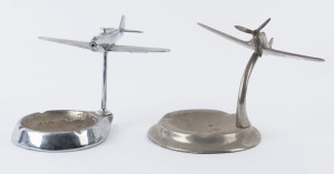 Two WW2 period chrome finished aeroplane ornament ashtrays, the larger 15cm across the wings