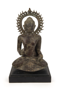 An antique cast bronze Buddha statue, 19th/20th century, on later ebonized wooden plinth, 44cm high overall