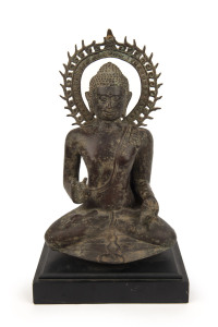 An antique cast bronze Buddha statue, 19th/20th century, on later ebonized wooden plinth, ​44cm high overall