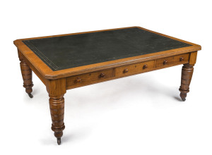 An antique English oak library table with six drawers and inset embossed black leather top with gilt tooling, late 19th century, 75cm high, 184cm wide, 126cm deep