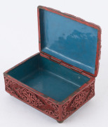 A Chinese cinnabar lacquer box, early 20th century Decorated to the hinged lid with a scrolling dragon, and floral motifs to the sides. Cinnabar on cast brass ground with internal blue enamel finish. 5.5cm high, 11cm wide, 8cm deep. - 2