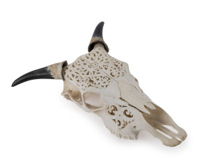 A carved cow skull ornament, 20th century, ​51cm high, 40cm wide