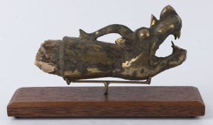 A Chinese dragon finial, gilt metal and wood, in the archaic style, 20cm long
