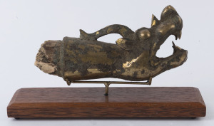 A Chinese dragon finial, gilt metal and wood, in the archaic style, ​20cm long