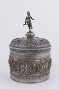 A stunning antique Burmese silver ceremonial betel box. Decorated with six deep repoussé cartouches showing Burmese mythological scenes with lotus and scroll frieze. The lid also beautifully worked in repoussé with seven further figural vignettes and a sp - 2