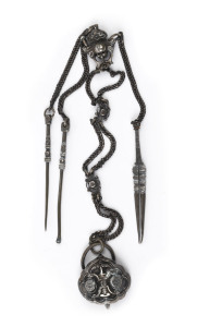 An antique Chinese silver gentleman's chatelaine grooming set, Qing Dynasty, 19th century. Comprising of an earpick, nail pick and tweezers hung from a long silver chain adorned with rosettes and a monkey face representing high rank and fertility. 34cm lo