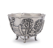 An outstanding antique Chinese silver bowl, double walled construction with superb repouss&eacute; floral decoration and stylized bamboo feet, 19th/20th century, seal mark to base, ​9cm high, 13cm wide, 312 grams