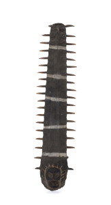 An early swordfish rostrum ornament with clay and shell face decoration and earth pigment finish, north coast Papua New Guinea, circa 1950, 39cm high