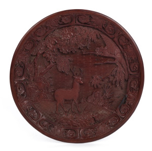A Chinese carved cinnabar lacquered platter, Qing Dynasty, late 18th century, Qianlong mark rendered in gold, ​30cm diameter
