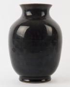 A Chinese porcelain vase with black glazed exterior, Qing Dynasty, 19th century, ​made in two sections, 29cm high