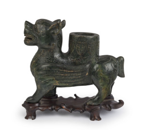 A Chinese carved green jade winged dragon with scroll work and incised decoration, on original wooden base, 19th/20th, 30cm high, 28cm long