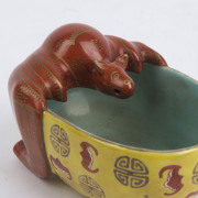 An antique Chinese porcelain washer in the form of a bat with Wan symbols, bats and Shou good luck symbols, 18th/19th century, Jiaqing underglaze blue six character mark, 5.5cm high, 10cm long. Note: A near identical example is illustrated in "JINGDEZHEN - 3