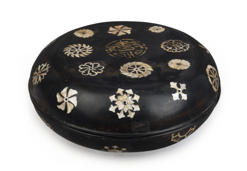 An 18th century Chinese Ryukyuan black lacquered covered bowl with mother of pearl inlay adorned with gilded Shou good luck symbol incorporating two Wan symbols, 15cm high, 39cm diameter. Note: A near identical example was auctioned at Sotheby's, London,