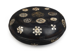 An 18th century Chinese Ryukyuan black lacquered covered bowl with mother of pearl inlay adorned with gilded Shou good luck symbol incorporating two Wan symbols, 15cm high, 39cm diameter. Note: A near identical example was auctioned at Sotheby's, London, 