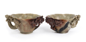 A pair antique Chinese libation cups, carved light green and russet soapstone with peony decoration, late 19th century, 6cm high, 14cm wide