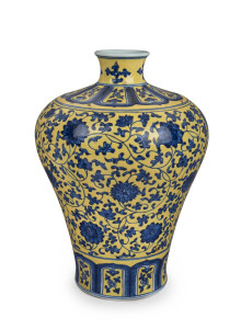 A Chinese Meiping porcelain vase, yellow overlay with underglaze blue decoration of lotus flowers, made in two parts luted at lower end of the neck, 19th/20th century. Note the yellow has continuous pitting to the glaze. Qianlong underglaze seal script mark to base, 32cm high