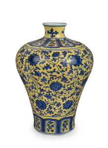 A Chinese Meiping porcelain vase, yellow overlay with underglaze blue decoration of lotus flowers, made in two parts luted at lower end of the neck, 19th/20th century. Note the yellow has continuous pitting to the glaze. Qianlong underglaze seal script ma