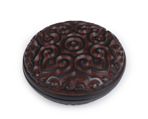 Tixi red and black Chinese lacquered box with finely carved Ju-i patterned lid and base, Qing Dynasty, 19th/20th century, 4cm high, 7.5cm diameter. Note: A similar example sold at Sotheby's Auctions, New York, 18th March, 2014, lot 249