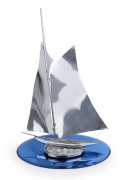 An Art Deco chrome yacht ornament on blue glass base, circa 1930, 39cm high, 29cm wide