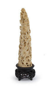 An antique Chinese carved ivory floral ornament on original carved wooden stand, early Republic Period, 17.5cm high overall