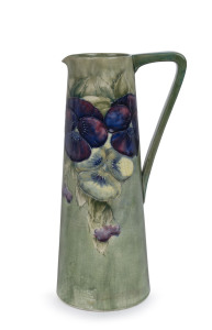MOORCROFT "Pansy" pattern ewer on celadon green ground, early 20th century, underglaze green signature "W. Moorcroft", 28cm high