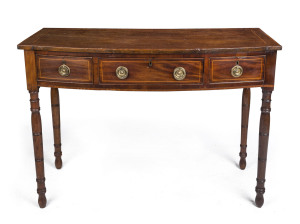 A Georgian bow front three drawer mahogany desk, cross banded in satinwood with cock beading and ring turned legs, early 19th century, 83cm high, 114cm wide, 51cm deep