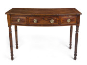 A Georgian bow front three drawer mahogany desk, cross banded in satinwood with cock beading and ring turned legs, early 19th century, ​83cm high, 114cm wide, 51cm deep