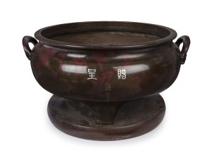 An impressive Japanese temple censer, cast bronze with pigeon blood splashing, inlaid with silver characters and engraved with verse, Meiji Period, 19th/20th century, 31cm high, 64cm across the handles