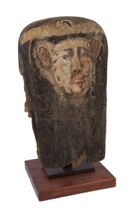 An Egyptian sarcophagus male face mummy mask, carved wood and pigment, late period 600 - 300 B.C. 66cm high. PROVENANCE: The S. Kovar Collection.