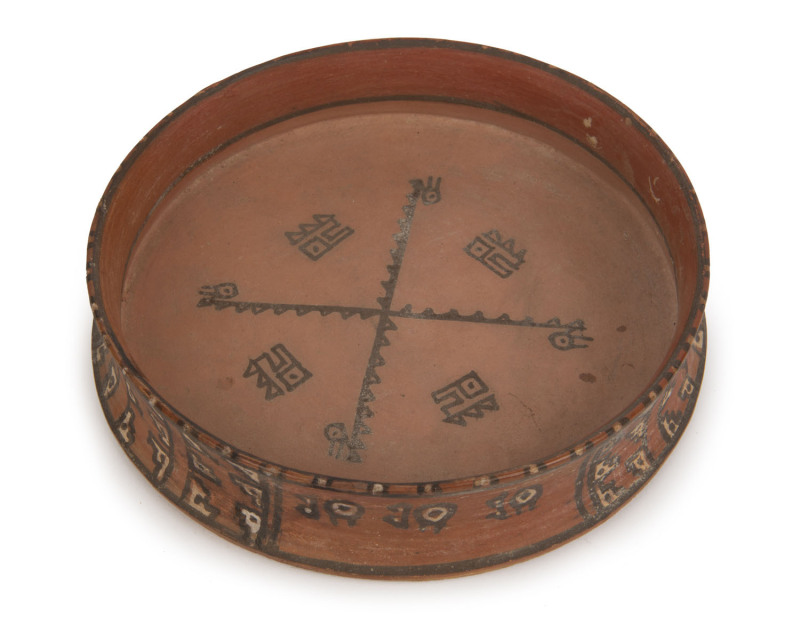 Pre-Columbian pottery dish with hand-painted designs in red, black and white pigments, Capuli culture, Highland Narino region, Columbia, circa 1200 A.D. 4cm high, 18cm diameter. PROVENANCE: The William Bowmore Collection, Mossgreen Auctions, 2008.