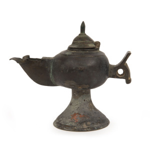 A Ghaznavid bronze oil lamp with lid, Central Asia, Ghaznavid Empire, circa 11th century, ​13cm high, 15cm wide