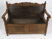 A Tudor revival hall seat, carved oak with caned back and lift-top compartment seat, circa 1920, ​94cm high, 125cm wide, 57cm deep - 2