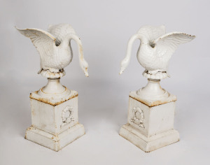 A pair of painted cast iron swan garden ornaments on stands, 20th century, 75cm high, 33cm wide, 45cm deep