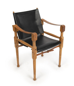 MICHAEL HIRST safari armchair, oak and leather, mid 20th century, stamped "Michael Hirst, Melbourne" on leather fitting at rear, 81cm high, 53cm across the arms
