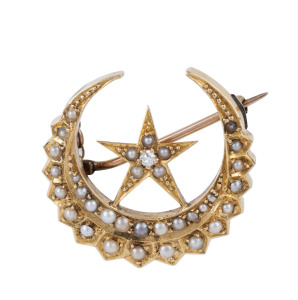 An antique crescent and star brooch set with diamond and seed pearls, circa 1900, 2.5cm wide, 4.3 grams
