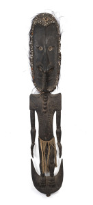 An impressive figural food hook, carved wood, feather, shell and fibre with remains of earth pigments, Papua New Guinea, ​177cm high