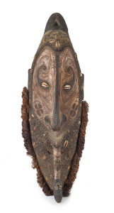 A spirit mask, carved wood, shell and fibre beard with clay and earth pigments, Papua New Guinea, 82cm high
