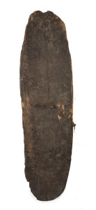 An early shield, carved wood with remains of woven fibre handle, Papua New Guinea, early 20th century, ​119cm high