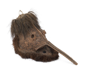 Long nose Tumbuan mask, woven cane, feather and fibre with remains of earth pigment decoration, Blackwater Lakes, Papua New Guinea, 42cm high, 72cm long