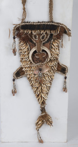 A pectoral chest ornament, dog's tooth, shell, tusk, fibre and ochre, Lower Ramu River, Papua New Guinea, 63cm high